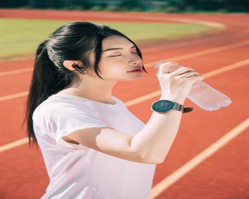 Asian woman drinking water after exercise